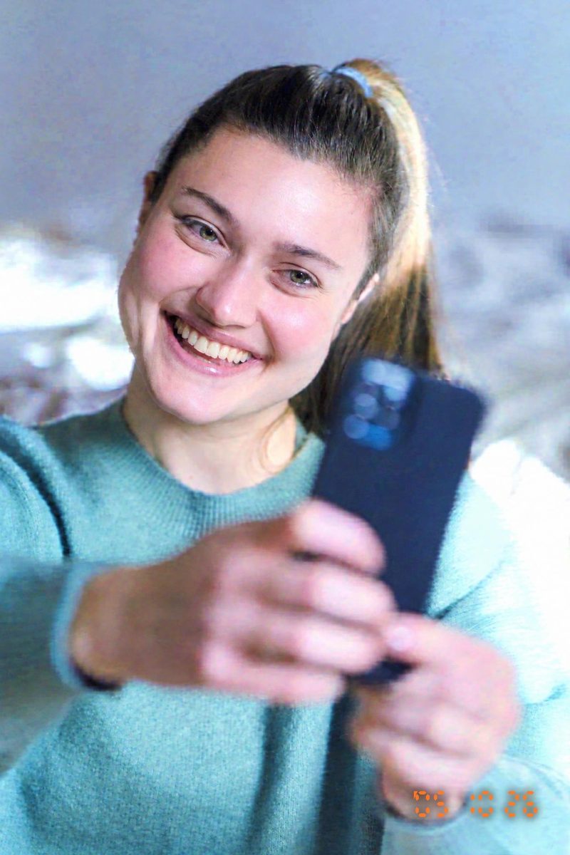 AI-generated: 2000s Date Stamp AI filter result: young woman taking a selfie