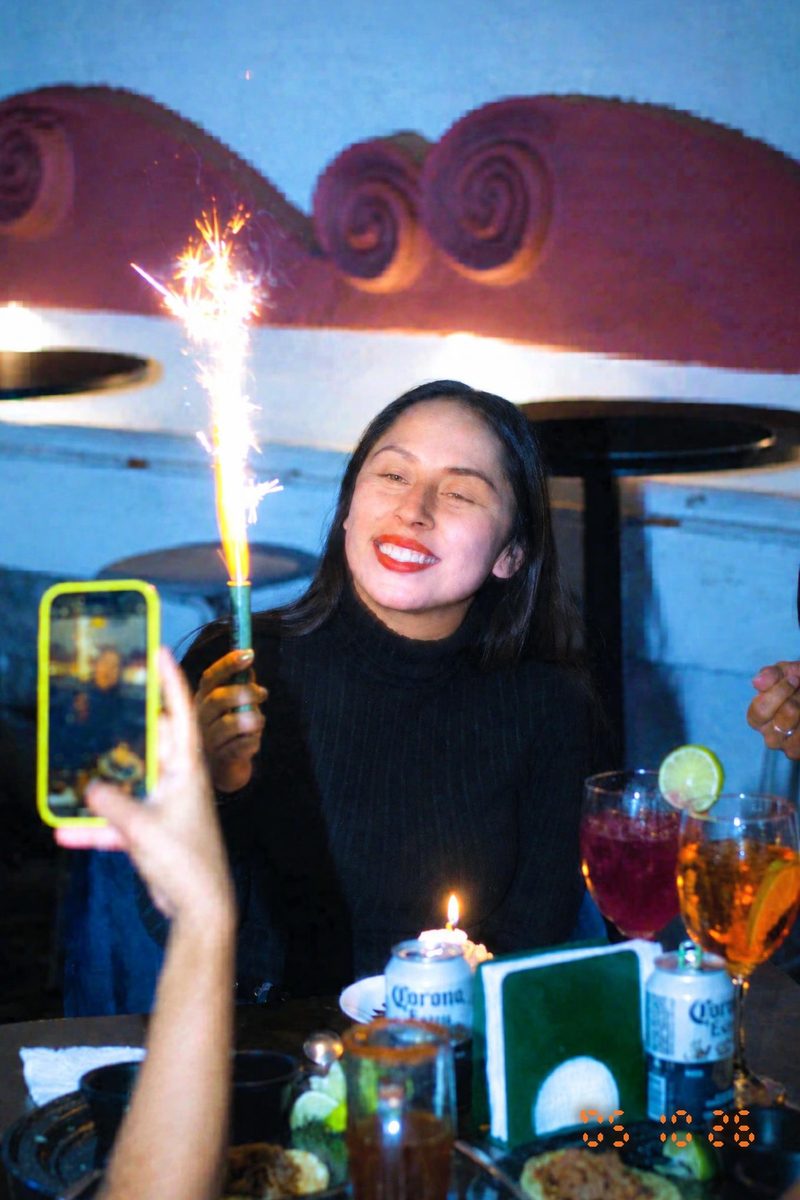 AI-generated: 2000s Date Stamp AI filter result: woman celebrating a birthday with a sparkler