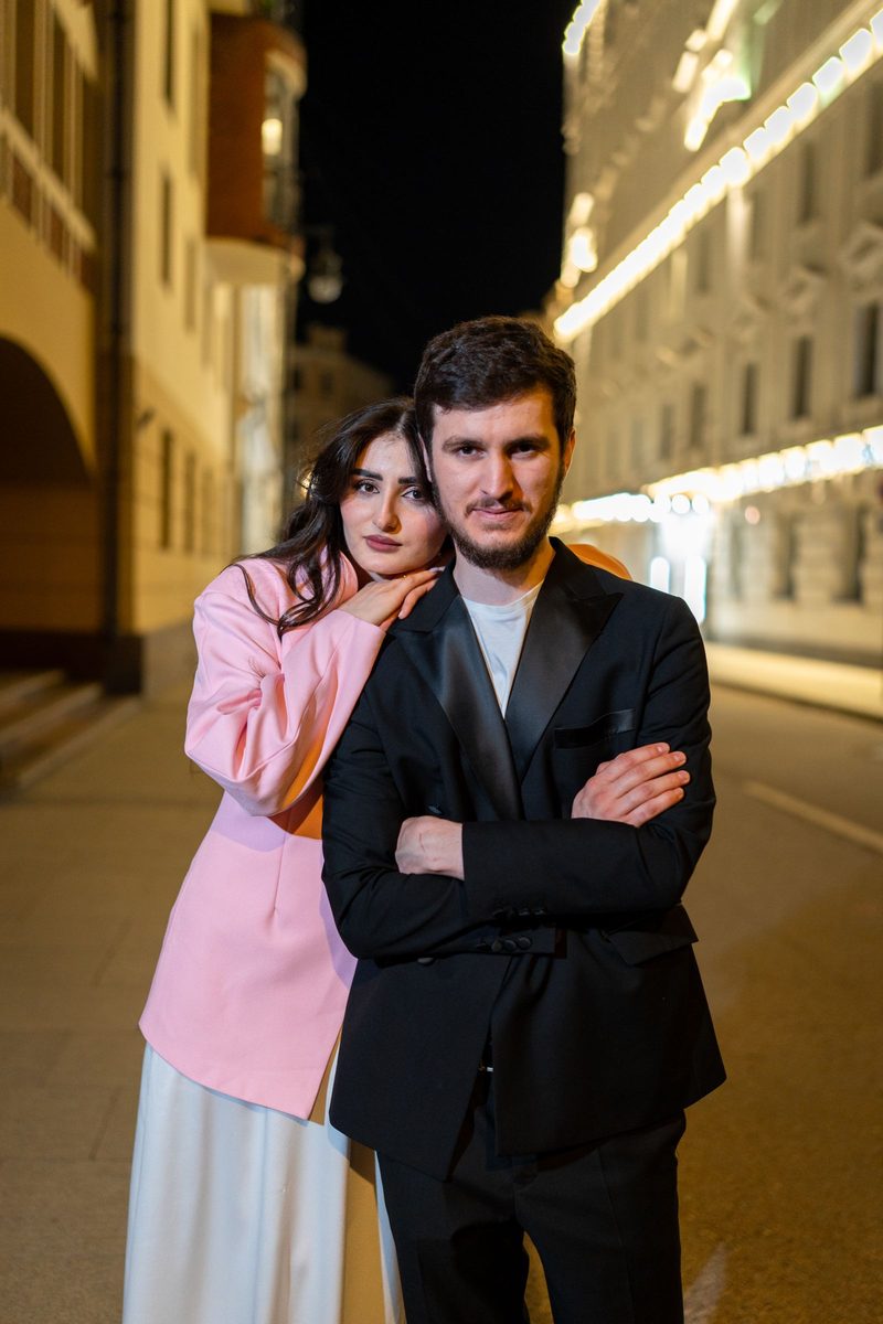Before: 2000s Date Stamp AI filter result: stylish couple on a city street at night