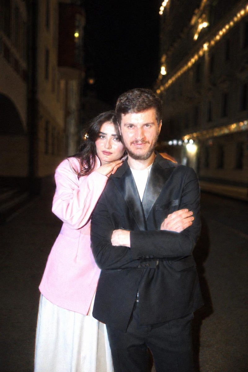 AI-generated: CCD Night Flash AI filter result: stylish couple on a city street at night