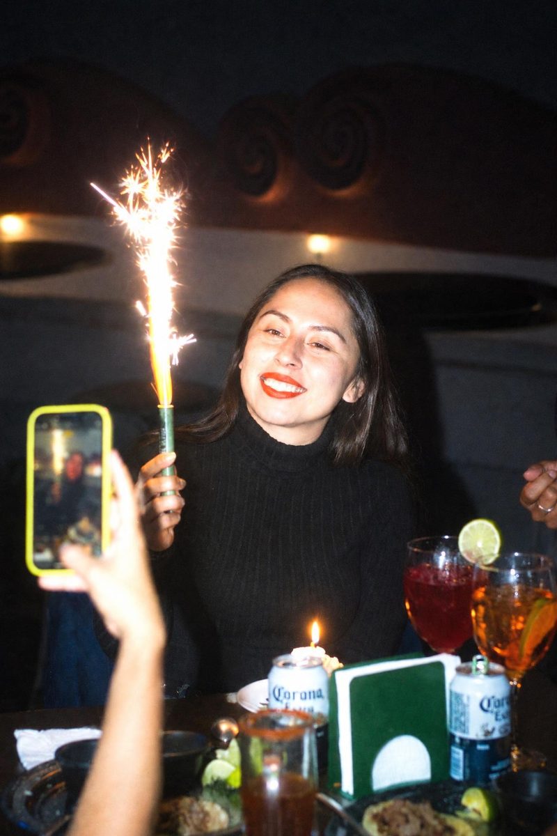 AI-generated: CCD Night Flash AI filter result: woman celebrating a birthday with a sparkler