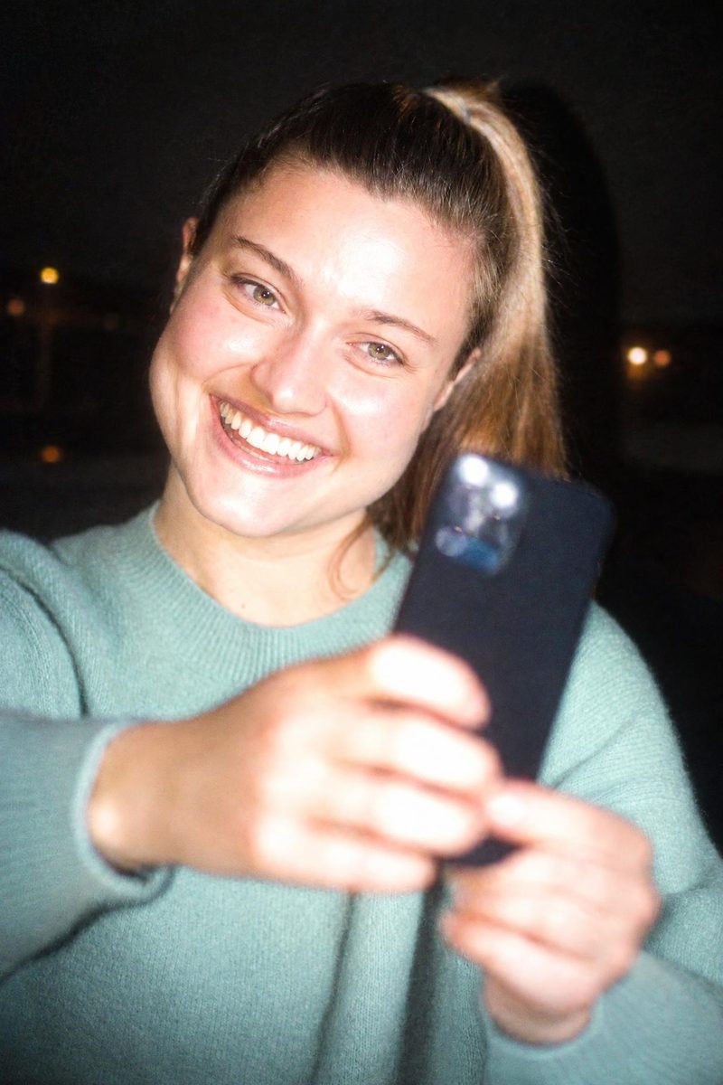 AI-generated: CCD Night Flash AI filter result: young woman taking a selfie