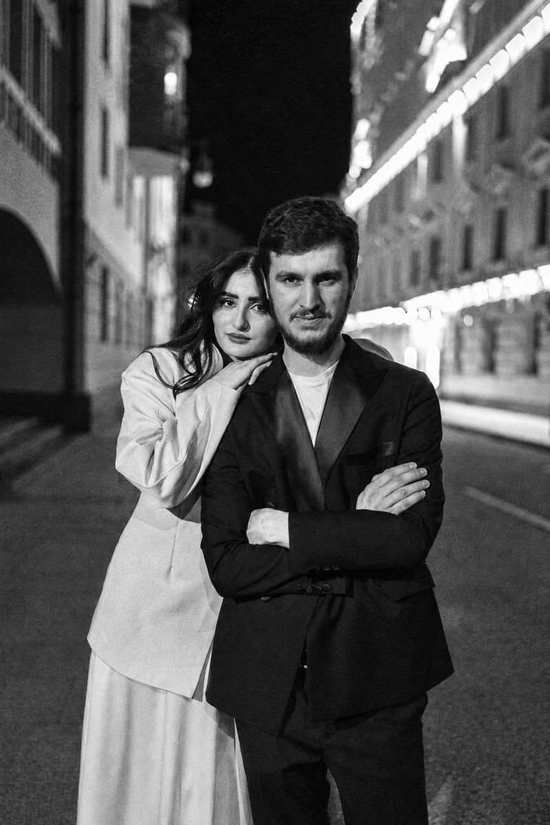 AI-generated: Classic B&W Film AI filter result: stylish couple on a city street at night