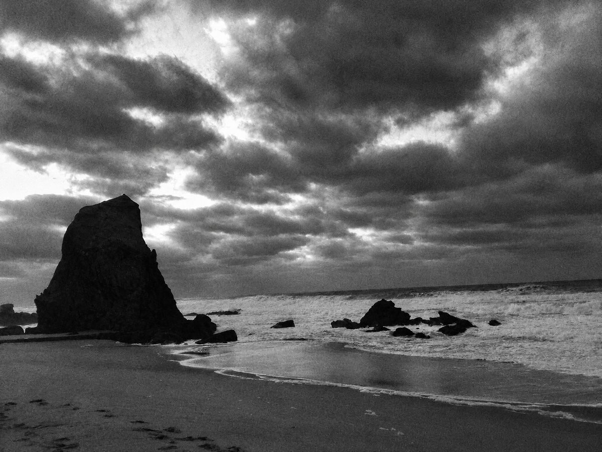 AI-generated: Classic B&W Film AI filter result: rocky beach under a cloudy sky