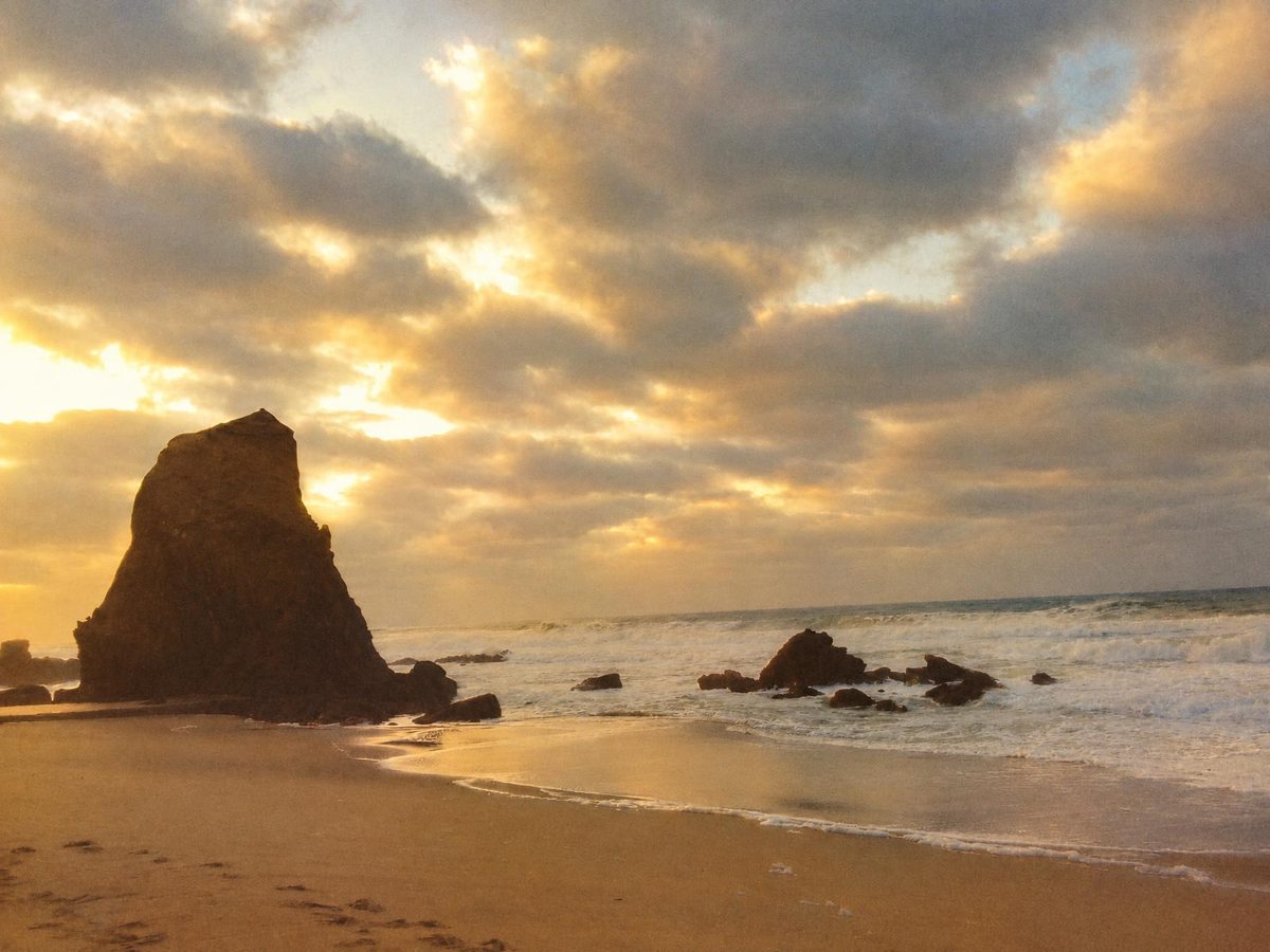AI-generated: Gold 200 Film AI filter result: rocky beach under a cloudy sky