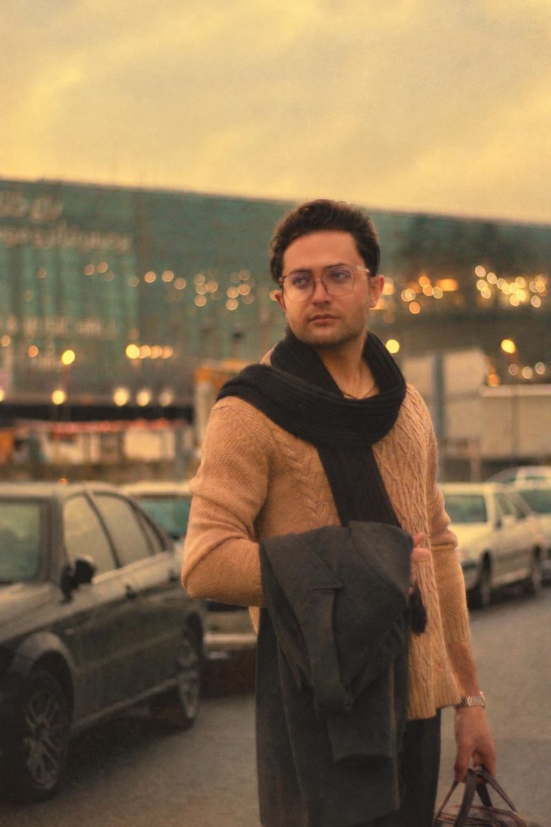 AI-generated: Gold 200 Film AI filter result: man in a brown sweater and scarf on a city street