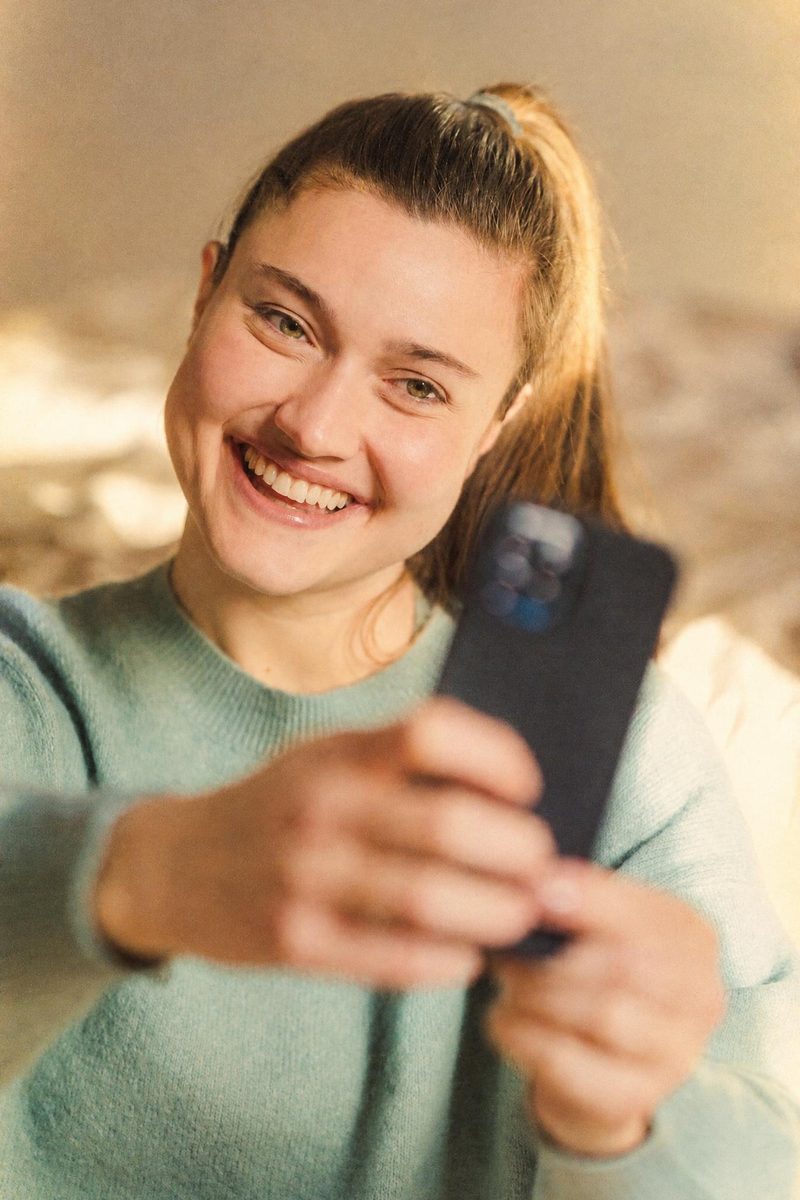 AI-generated: Gold 200 Film AI filter result: young woman taking a selfie
