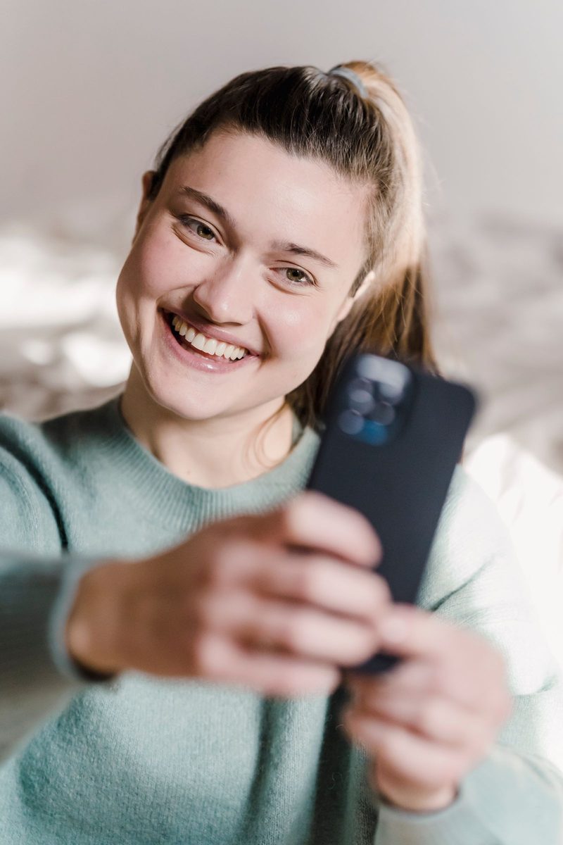 Before: Gold 200 Film AI filter result: young woman taking a selfie