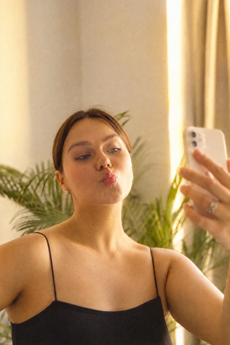 AI-generated: Gold 200 Film AI filter result: woman in a black top taking a mirror selfie