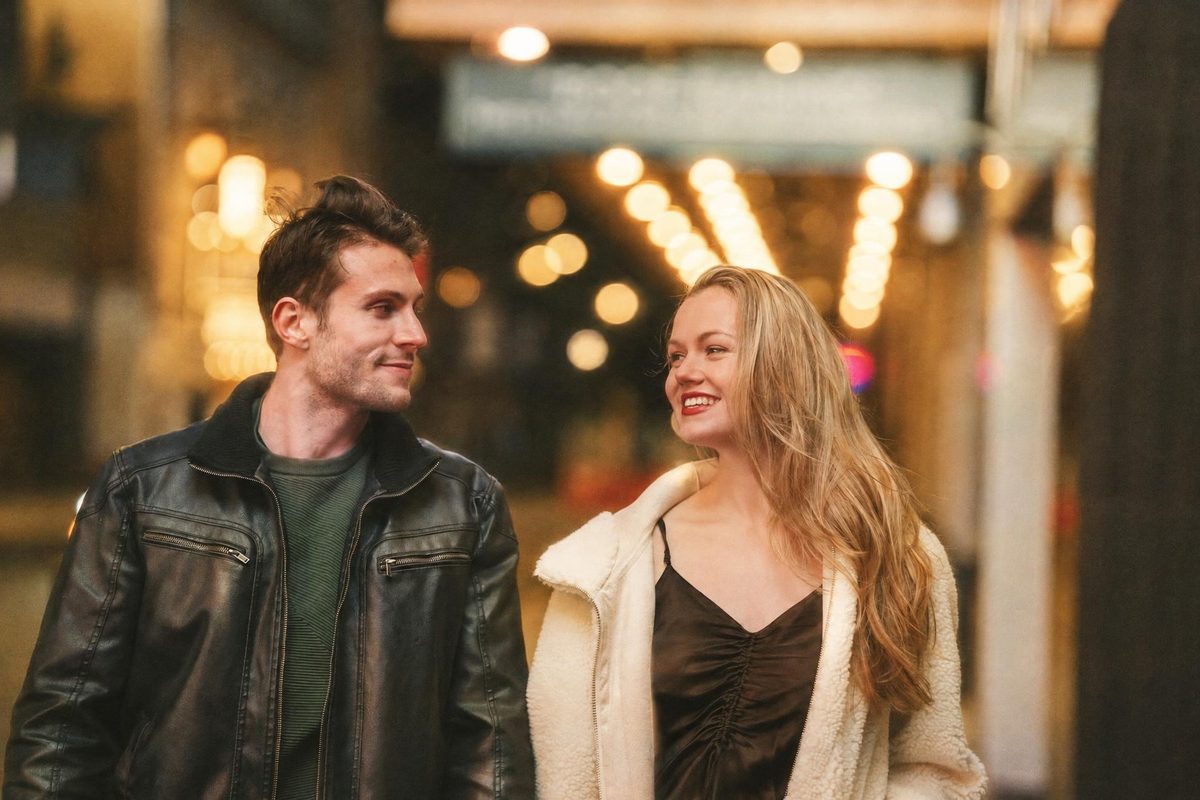 AI-generated: Gold 200 Film AI filter result: smiling couple walking down a street at night