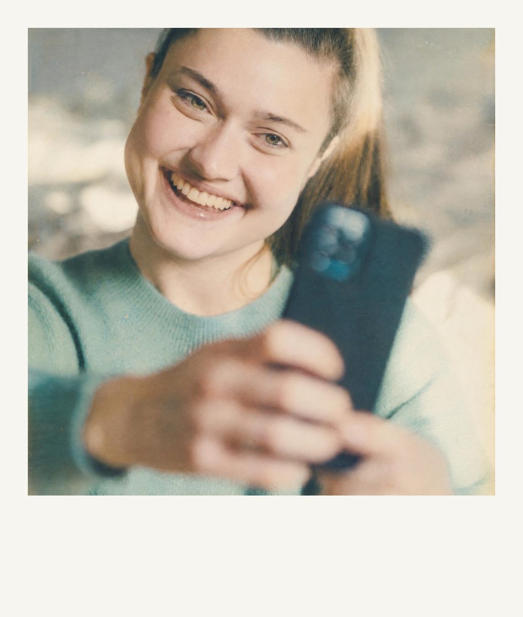 AI-generated: Instant Film Frame AI filter result: young woman taking a selfie