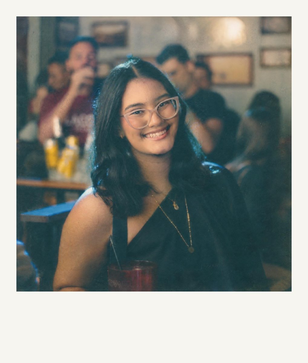 AI-generated: Instant Film Frame AI filter result: smiling woman with a drink on a night out at a bar