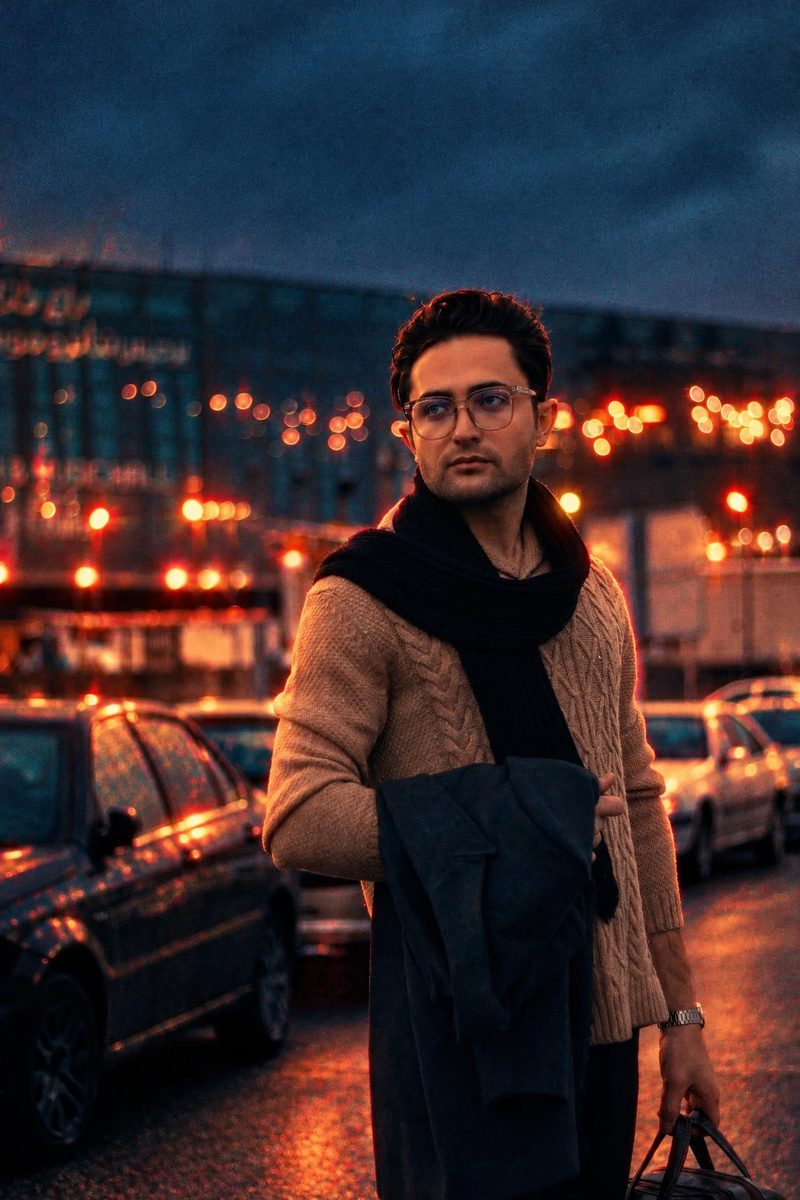 AI-generated: Night Tungsten 800 AI filter result: man in a brown sweater and scarf on a city street