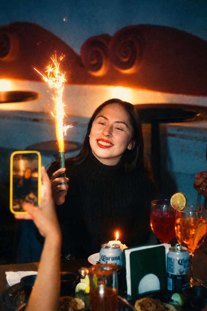 AI-generated: Night Tungsten 800 AI filter result: woman celebrating a birthday with a sparkler