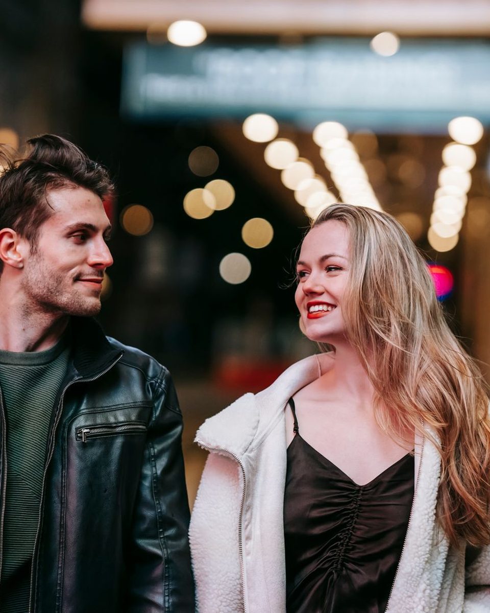 Before: Photobooth Strip AI filter result: smiling couple walking down a street at night