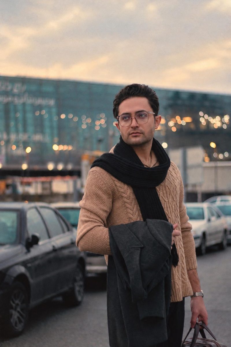 AI-generated: Warm Portrait 400 AI filter result: man in a brown sweater and scarf on a city street
