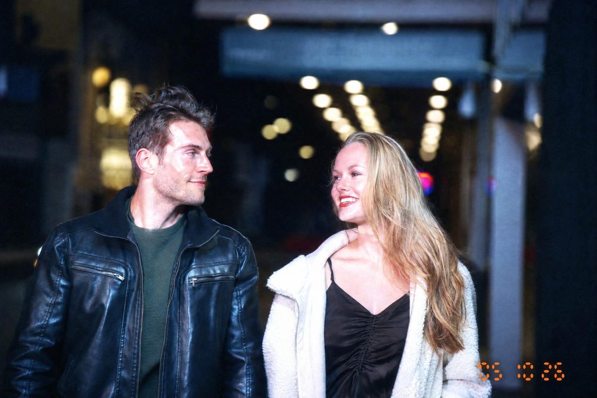 AI-generated: Y2K Compact Digicam AI filter result: smiling couple walking down a street at night